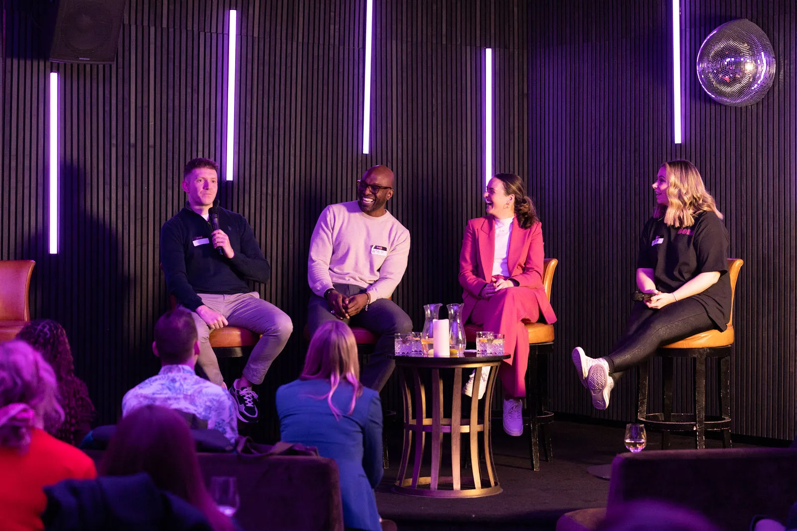Sam Millward speaking to an audience at a London business event